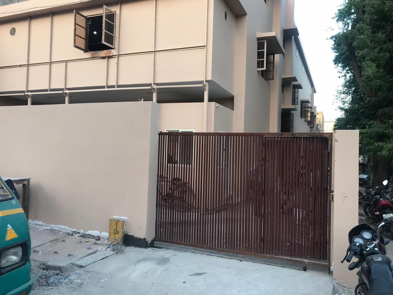 The E-43/7 building in Okhla from the street, with its entrance gate.